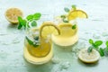 Lemonade with mint. Lemon water drink with ice. Two glasses and lemons Royalty Free Stock Photo