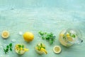 Lemonade with mint. Lemon water drink with ice. Two glasses and a pitcher Royalty Free Stock Photo