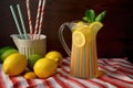 lemonade pitcher with colorful paper straws and napkins