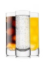 Lemonade soft drink with cola and orange soda with ice cubes in highball glasses on white background Royalty Free Stock Photo