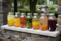 lemonade stand with a variety of flavors and sizes, from small glass bottles to large refillable pitchers