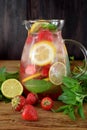 Lemonade with strawberry, lemon, mint, lime and ice cubes Royalty Free Stock Photo