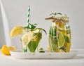 Lemonade in a transparent glass with lemon, lime, rosemary sprigs and mint leaves on a white background Royalty Free Stock Photo