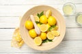 Lemonades and bowl with lemons on background, top view