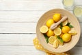 Lemonades and bowl with lemons on background, top view