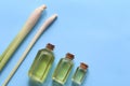 Lemongrass essential oil in glass bottles on blue background Royalty Free Stock Photo