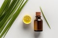 Lemongrass Essential Oil In Small Brown Bottle Next To Lemongrass On White Background, Top View. Generative AI