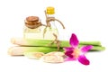 Lemongrass oil in clear bottles and bergamot, orchid flowers, placed on a sack. Royalty Free Stock Photo