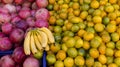 Lemons, bananas, apples, tangerines and pear on a table of wooden planks Royalty Free Stock Photo