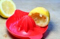 Lemons being juiced in a hand juicer. Royalty Free Stock Photo