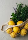 Lemons and Herbs in a Mesh Bag on Beige Fabric Royalty Free Stock Photo