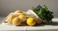Lemons and Herbs in Mesh Bag on White Table Royalty Free Stock Photo