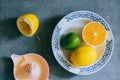 Lemons, lime, orange in a white ceramic plate Royalty Free Stock Photo
