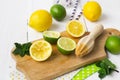 Lemons, limes, mint cocktail preparation on a wooden background Royalty Free Stock Photo