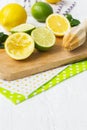 Lemons, limes, mint cocktail preparation on a wooden background Royalty Free Stock Photo