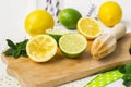 Lemons, limes, mint cocktail preparation on a wooden background Royalty Free Stock Photo