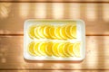 Lemons or Limes are slied for ingredient to cook and beverage. It`s arranged on the rectangle white bowl square on wooden table Royalty Free Stock Photo
