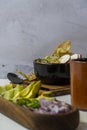 lemons for meat dish in its juice with corn tortilla chips, glass with horchata water, mexican food