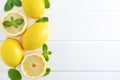 Lemons and mint on a white wooden background