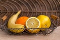 Lemons, oranges and a banana arranged in wicker basket Royalty Free Stock Photo