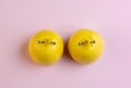 Lemons in shape of woman breast with nipple piercing on pink background Royalty Free Stock Photo