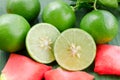 Lemons with slices and rose petals on banana leaf background Royalty Free Stock Photo