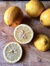Lemons, slices and whole on a wooden board