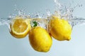Fresh Lemons Splashing into Water with Dynamic Splash Royalty Free Stock Photo
