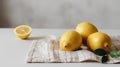 Lemons on a white tablecloth on a gray background. Royalty Free Stock Photo