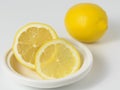 Lemons whole and sliced on a white background.