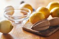 Lemons with wooden reamer ready to be juiced and squeezed