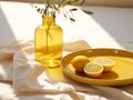 lemons on yellow ceramic plate, and yellow glass vase on a table with a light napkin