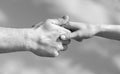 Lending a helping hand. Hands of man and woman reaching to each other, support. Solidarity, compassion, and charity Royalty Free Stock Photo