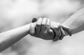 Lending a helping hand. Hands of man and woman reaching to each other, support. Solidarity, compassion, and charity Royalty Free Stock Photo