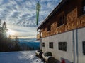 Lengries, Germany - December 28th 2022: Beautiful guest house high above the valley in the evening sunlight.