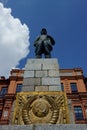 Lenin monument on background of blue sky and brick building Royalty Free Stock Photo