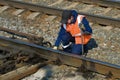 The railway worker customizes the railway railroad switch