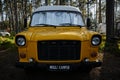 Leningrad Region, Russia - June 2022. Camping for cars in nature in a pine forest. The old stylish yellow shiny retro