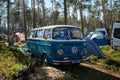 Leningrad Region, Russia - June 2022. Festival mobile homes in coniferous forest. Camping for tents and cars. Mobile