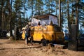 Leningrad Region, Russia - June 2022. Old stylish yellow retro hippie mobile for DJ with rising roof, speakers and music