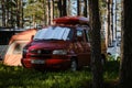 Leningrad Region, Russia - June 2022. Stylish red Volkswagen transporter with box on roof - house on wheels from minivan