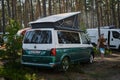 Leningrad Region, Russia - June 2022. Stylish Volkswagen transporter California with raised roof tent - house on wheels