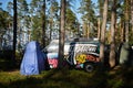 Leningrad Region, Russia - June 2022. Stylish Volkswagen transporter T4 decorated with graffiti with sup surf on roof -