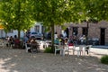 Lennik, Flemish Brabant Region, Belgium - People sitting on a terrace in the shadow