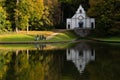 Lennik, Flemish Brabant Region, Belgium - White building of the Gaasbeek castle reflecting with families walking in
