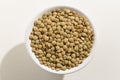 Lentil legume. Top view of grains in a bowl. White background. Royalty Free Stock Photo