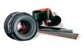 Lens & film strip on white Royalty Free Stock Photo