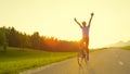 LENS FLARE: Professional cyclist outstretches his arms to the sky to celebrate.