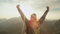 LENS FLARE: Golden sun rays shine on young couple hiking up a steep hill in Alps Royalty Free Stock Photo