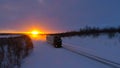 LENS FLARE: Large truck speeding down empty road through the wintry landscape. Royalty Free Stock Photo